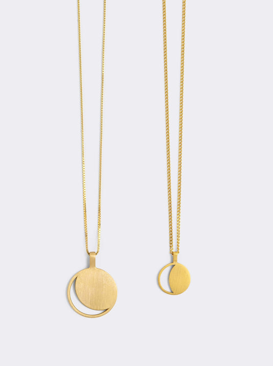 Two Hemi & Zo gold Moon Phase necklaces, one with a large pendant, one with a small pendant, presented against a white background