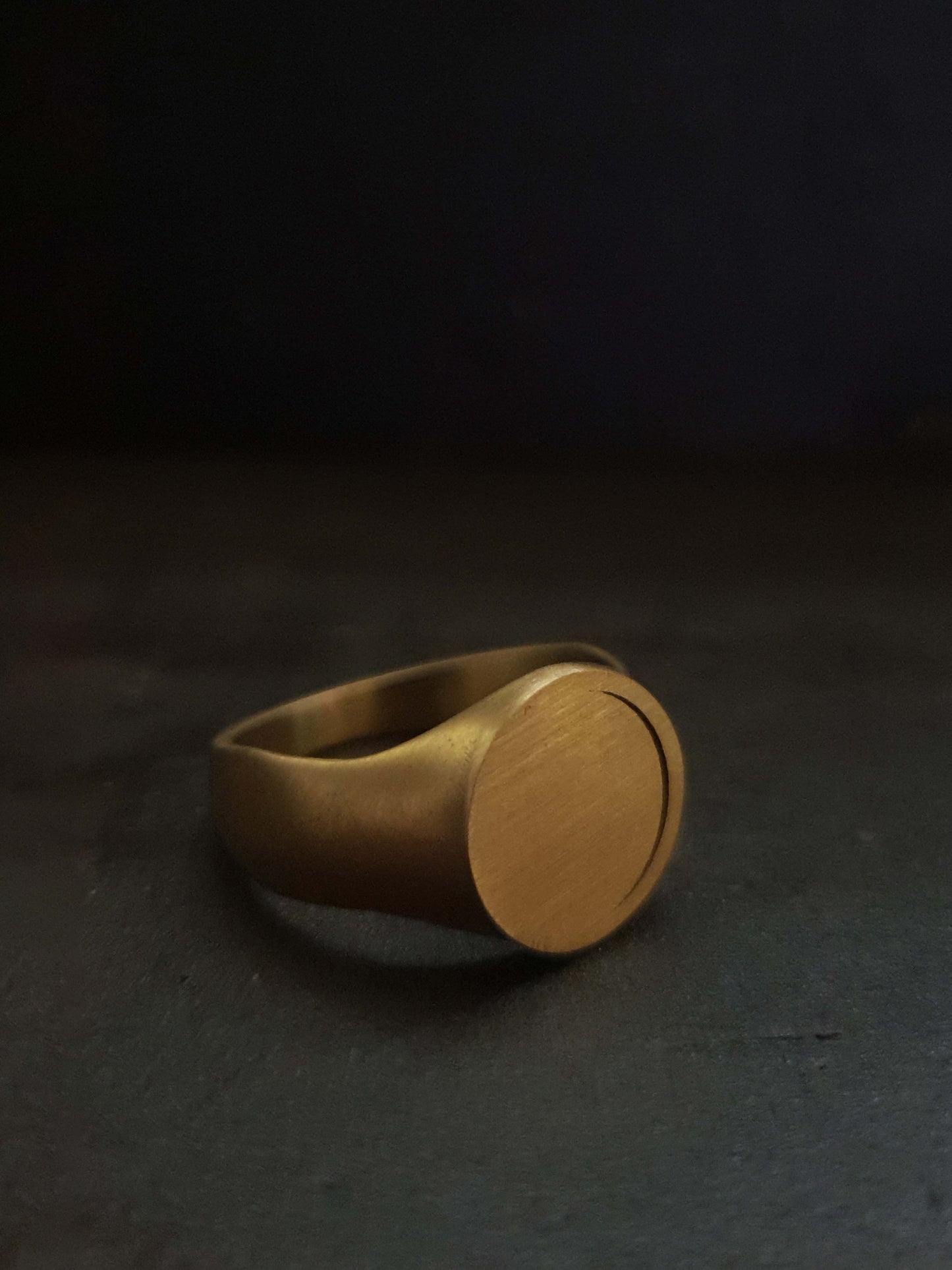 Hemi & Zo 18k yellow gold Moon Phase ring presented on a dark background