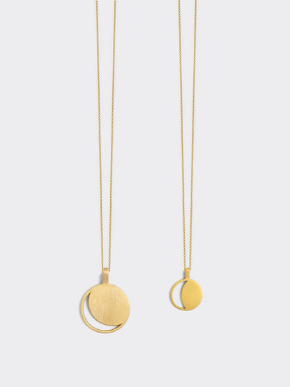 Two Hemi & Zo gold Moon Phase necklaces, one with a large pendant, one with a small pendant, presented against a white background