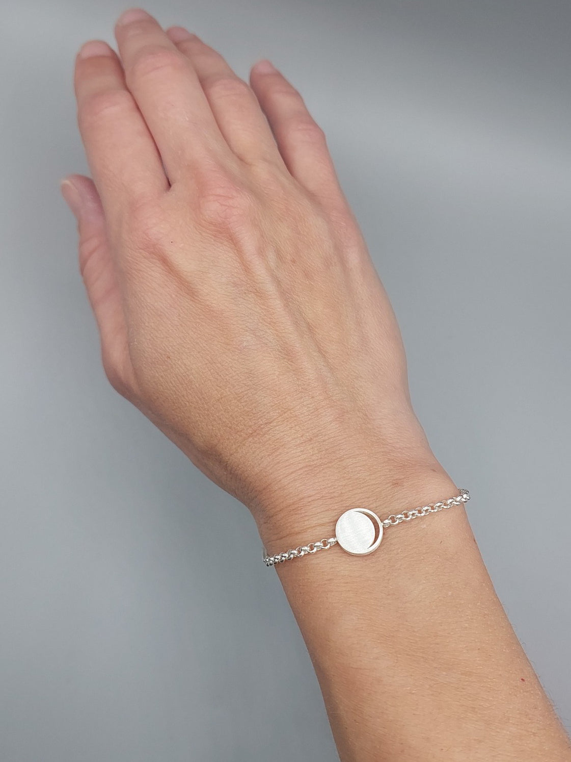 Hemi & Zo silver Moon Phase bracelet on a woman’s hand