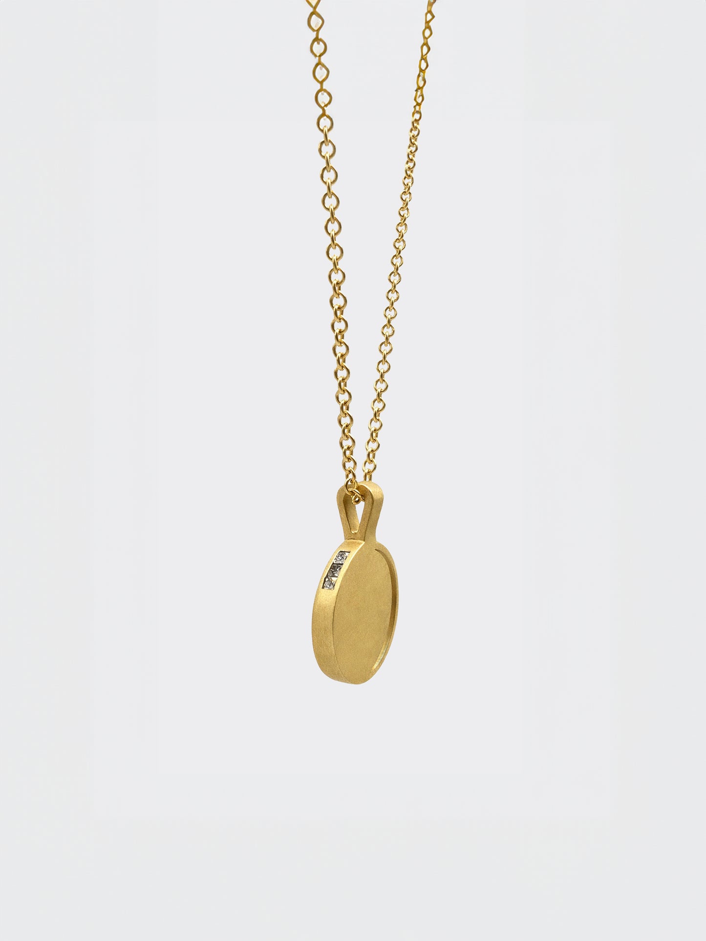 Hemi & Zo 14k gold Moon Phase necklace with 3 princess cut diamonds on a white background
