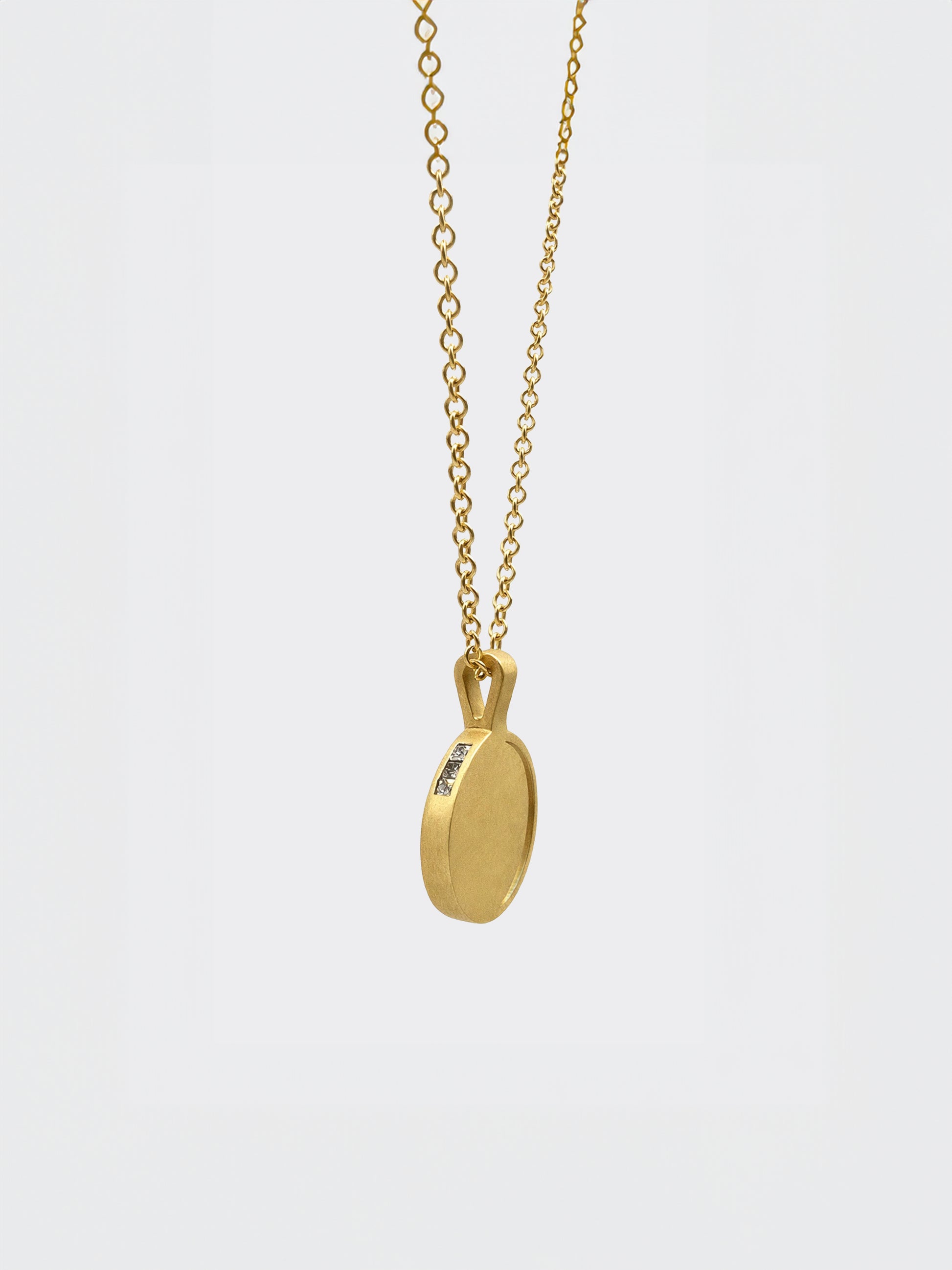 Hemi & Zo 14k gold Moon Phase necklace with 3 princess cut diamonds on a white background