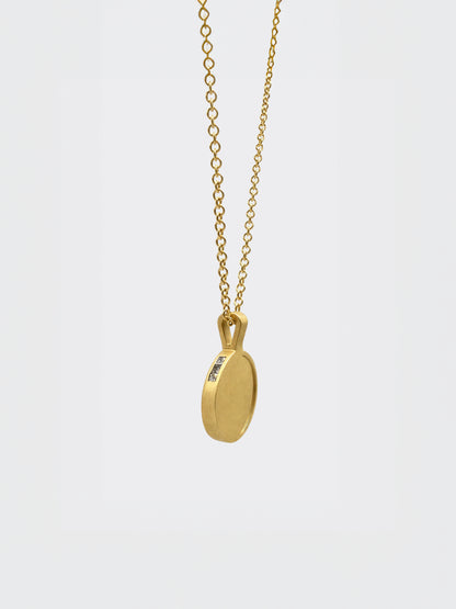 Hemi & Zo 14k gold Moon Phase necklace with 3 princess cut diamonds on a white background