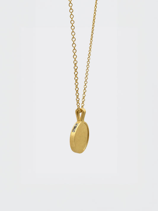 Hemi & Zo 14k gold Moon Phase necklace with 3 princess cut diamonds on a white background